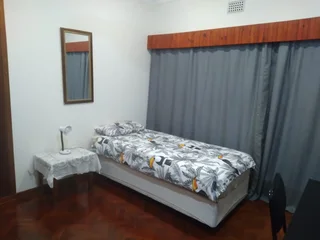 Furnished room to rent for employed singles in 5 bedroom house; can work online; services included.