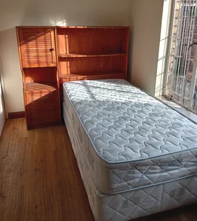 Single bed with table and chair