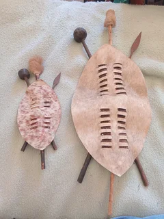 Set of two Zulu shields with knobkerries and spears