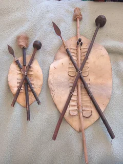 Set of two Zulu shields with knobkerries and spears
