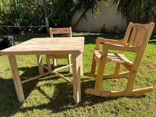 Kids  table with rocking chair and one extra chair.