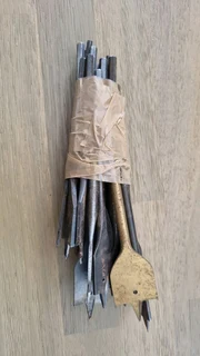 Various steel power drill bits in bundle.