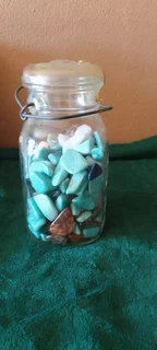 Decor Glass bottles, some with stones, or shells,  and candleholder