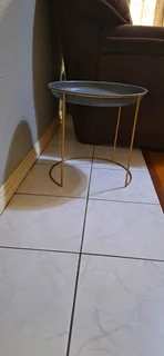 Stylish side table with golden brass legs
