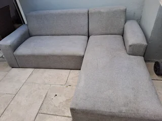 L SHAPE LOUNGE SUITE AND A BLACK ROCKING CHAIR