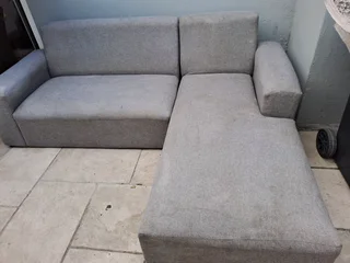 L SHAPE LOUNGE SUITE AND A BLACK ROCKING CHAIR