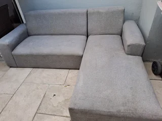 L SHAPE LOUNGE SUITE AND A BLACK ROCKING CHAIR