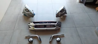 Isuzu front grill assymbly: Lights, fog lights, grill and chrome trim.
