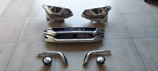 Isuzu front grill assymbly: Lights, fog lights, grill and chrome trim.