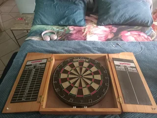 Used Dart board in wooden box