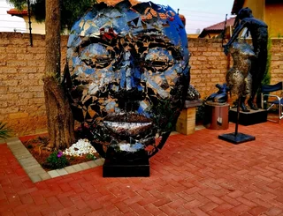 Massive Metal Mask Sculpture on Metal Base