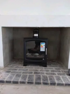 Heeta 600 cast Iron fireplace with stainless steel flue kit.