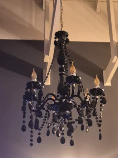 Black crystal chandeliers and wall sconces
