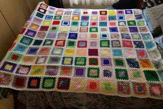 Hand knitted and crocheted baby blankets, jerseys, beanies and bootee