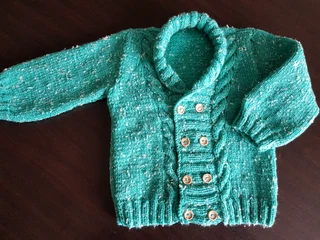 Hand knitted and crocheted baby garments and blankets
