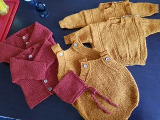 Hand crocheted and knitted baby garments and blankets of all shapes and sizes