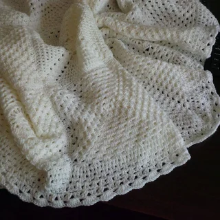 Hand crocheted and knitted baby garments and blankets of all shapes and sizes
