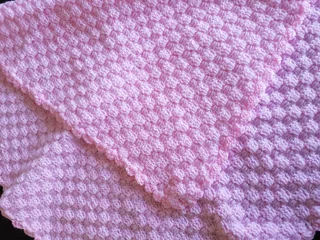 Hand crocheted and knitted baby garments and blankets of all shapes and sizes