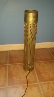 Household decorative ordnance  shell repurposed to a standing light in good condition.