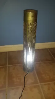 Household decorative ordnance  shell repurposed to a standing light in good condition.