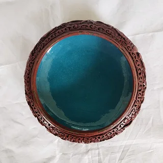 Cinnabar lacquer bowl with a turquoise-blue enamel interior.