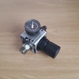 Pneumatic pressure reducing valve with built in pressure gauge.