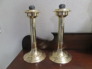 Pair of brass spring loaded candlesticks
