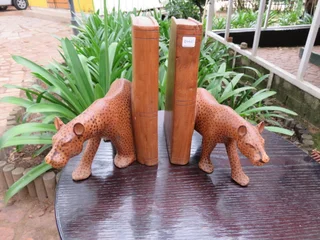 Pair of large wooden bookends with leopards