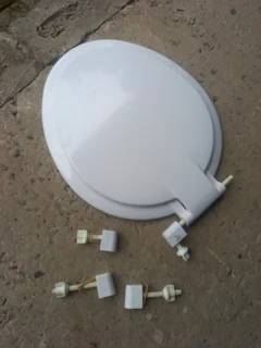 Small tiles  and a toilet seat.