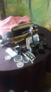 Cp 7m chinon slr camera with multiple accessories.
