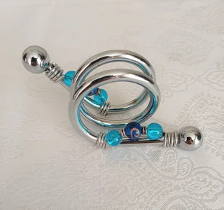 Serviette rings adorned with blue acrylic beads.