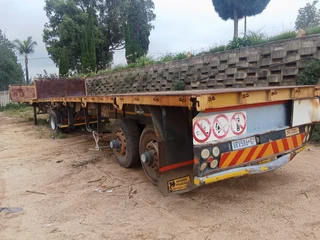 2005 Hendred Fruehauf 6 meter Front and 12 meter Rear Interlinked Flat Bed Trailers with Drop Sides.