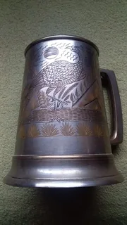 Antique beer mug with engravings and glass bottom
