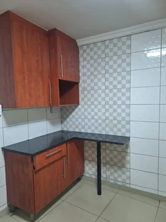 A secured room  for rental ,room with kitchenette and build -in cupboards .