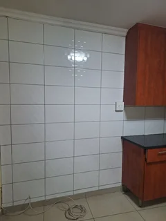 A secured room  for rental ,room with kitchenette and build -in cupboards .