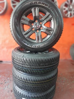 set of 265/65/17 dunlop and rims for sale