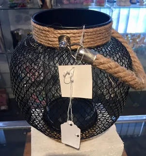 Lantern with glass candle holder inside and rope handle