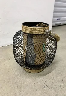 Lantern with glass candle holder inside and rope handle