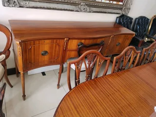 An elegant antique 10 seater dinning suite with a server in exceptional condition.