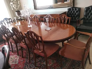 An elegant antique 10 seater dinning suite with a server in exceptional condition.