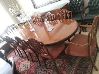 An elegant antique 10 seater dinning suite with a server in exceptional condition.