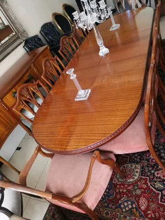An elegant antique 10 seater dinning suite with a server in exceptional condition.