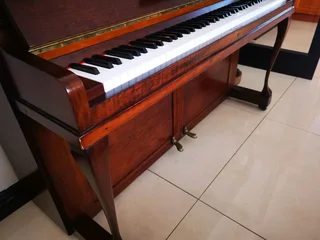 An antique Hoffmann Piano with a stool in exceptional condition