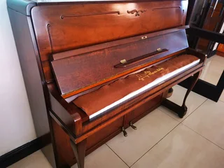 An antique Hoffmann Piano with a stool in exceptional condition