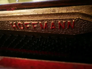 An antique Hoffmann Piano with a stool in exceptional condition
