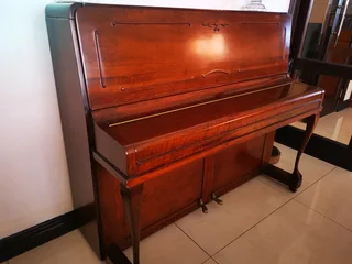 An antique Hoffmann Piano with a stool in exceptional condition