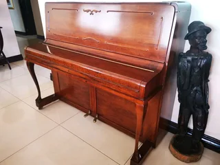 An antique Hoffmann Piano with a stool in exceptional condition