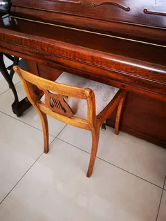 An antique Hoffmann Piano with a stool in exceptional condition