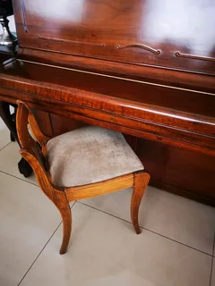 An antique Hoffmann Piano with a stool in exceptional condition