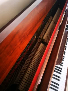 An antique Hoffmann Piano with a stool in exceptional condition